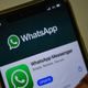 In this photo illustration taken on November 6, 2020, a user updates Facebook’s WhatsApp application on his mobile phone in Mumbai.